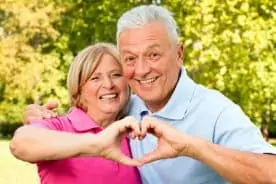 Parents over 70 smiling with an affordable life coverage